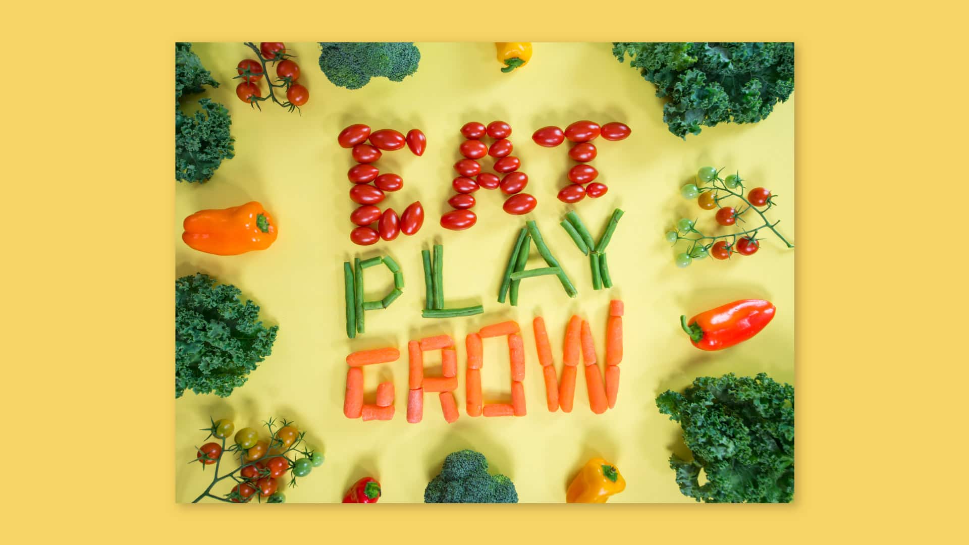 Eat play grow spelled with carrots, tomatoes and green beans